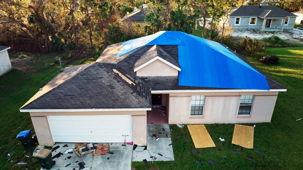 Insurance claims for a storm damaged roof that is temporary tarped.